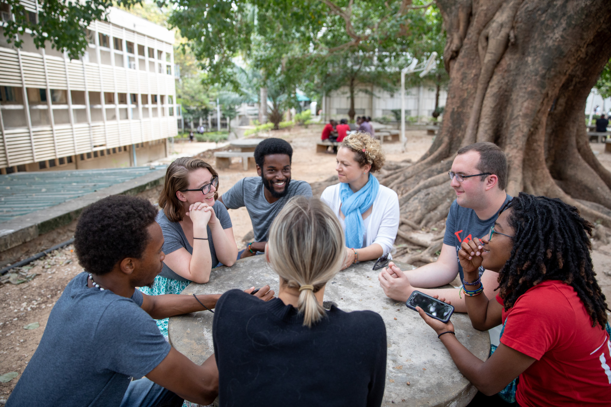 students gather around table